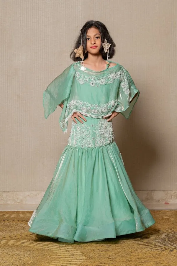 Elegant mint Green top and Lahenga with intricate white embroidery and a flowing silhouette, perfect for making a stylish statement at any festive occasion.