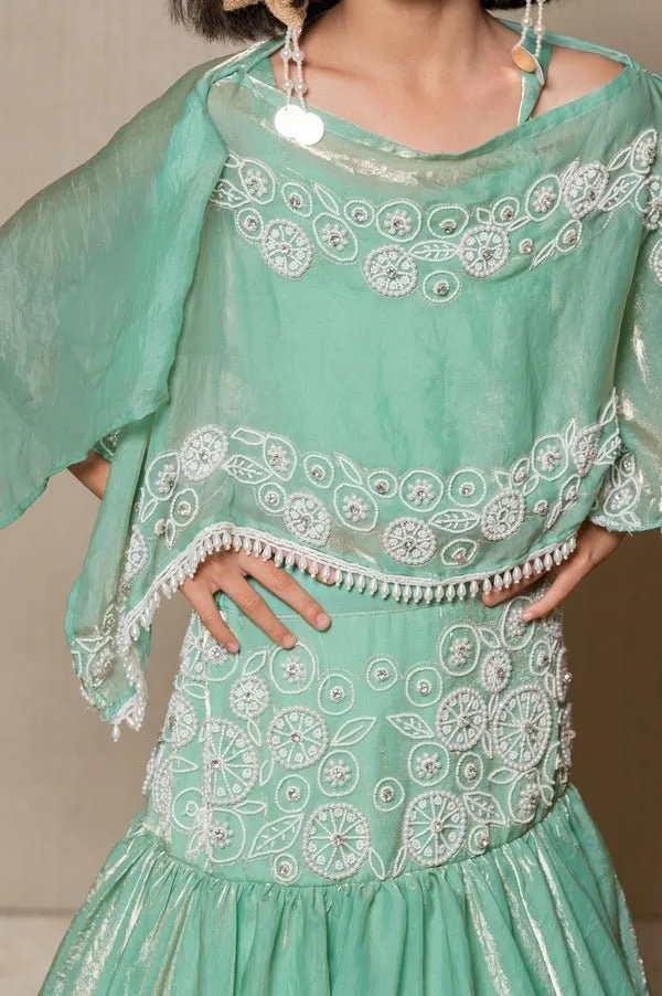 Elegant mint Green top and Lahenga with intricate white embroidery and a flowing silhouette, perfect for making a stylish statement at any festive occasion.